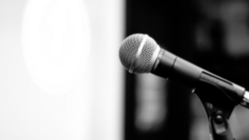 A slightly blurred microphone in black and white